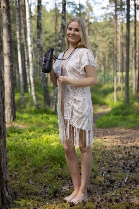 Blonde teen Lucia gets completely naked while in a mature forest 82110221