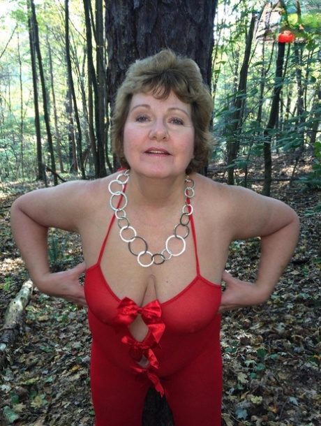 Older lady Busty Bliss gets completely naked while in a forest 35318779