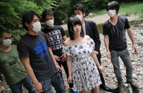 Cute Japanese girl Tsuna Kimura gives a bunch of boys oral sex on rocky ground 86094584
