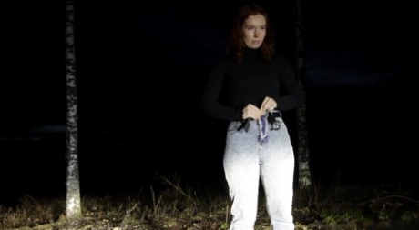 Redheaded girl Nikky B takes a badly needed pee on a road at night 88910732