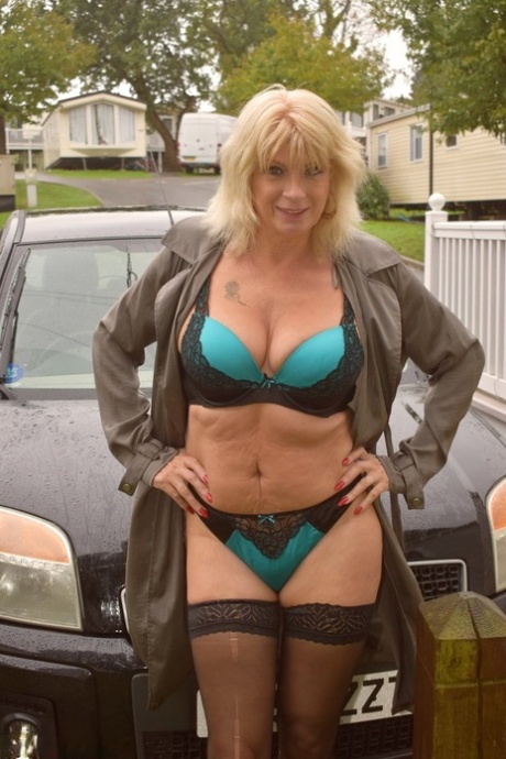 Older blonde Dimonty shows her natural tits during outdoor action by the water 62318920