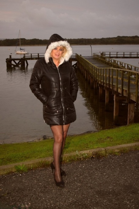 Older blonde Dimonty shows her natural tits during outdoor action by the water 62318920