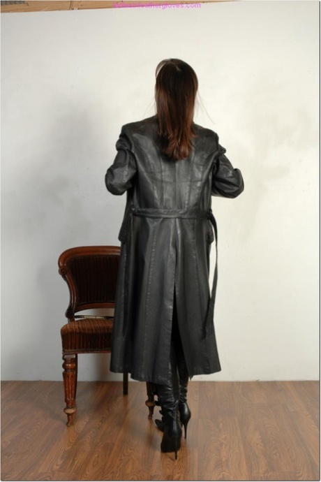 Brunette female dons long leather coat in leather boots and stockings 35210564