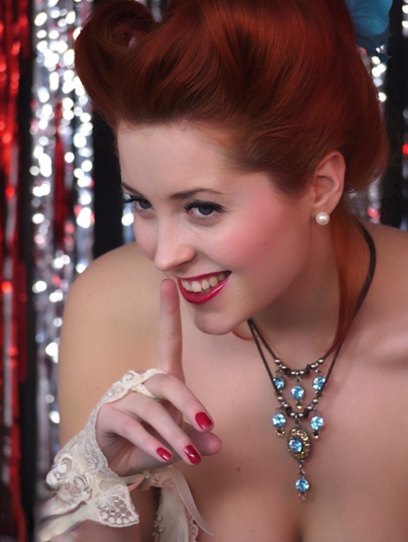 Gorgeous pinup model Lucy V strips burlesque style on a glittery stage 66957253