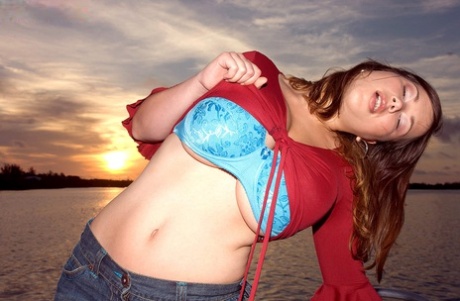 Solo girl Terry Nova slips a denim miniskirt over her butt on a sailboat