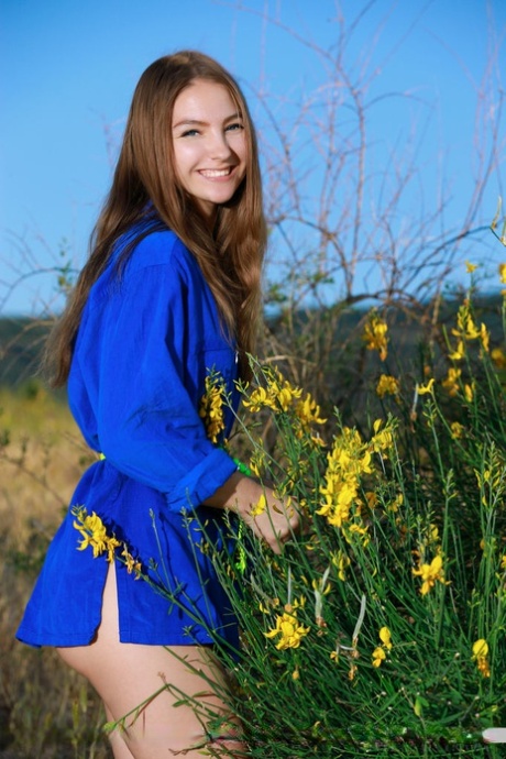 Russian teen Izabel A poses totally naked in front of a bush in bloom 54565263