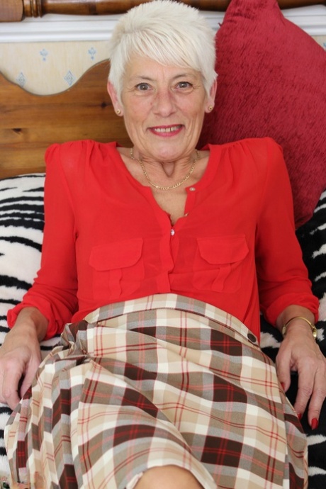 Over 70 Bristish granny takes off her clothes and lingerie striptease style 56845780