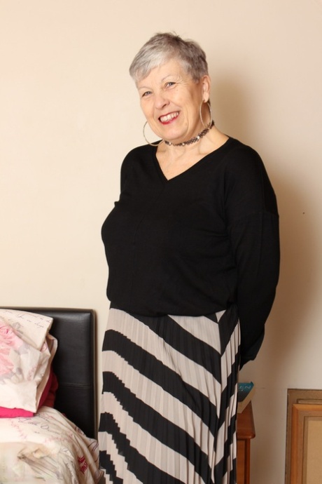 Thick grandmother from the UK squeezes her boobs together while disrobing 92904334