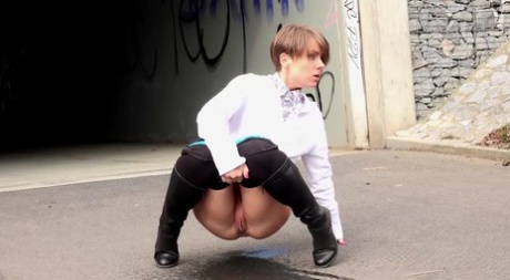 Short haired Shila in tall boots shows her shaved twat while peeing in public 24111972