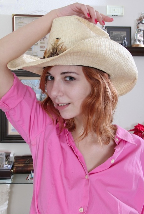 Amateur redhead Nancy Reid posing in cutoff shorts and cowgirl hat 98711917